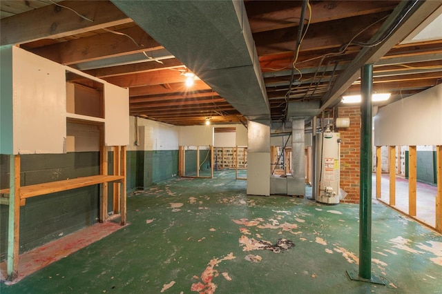 basement featuring heating unit and gas water heater