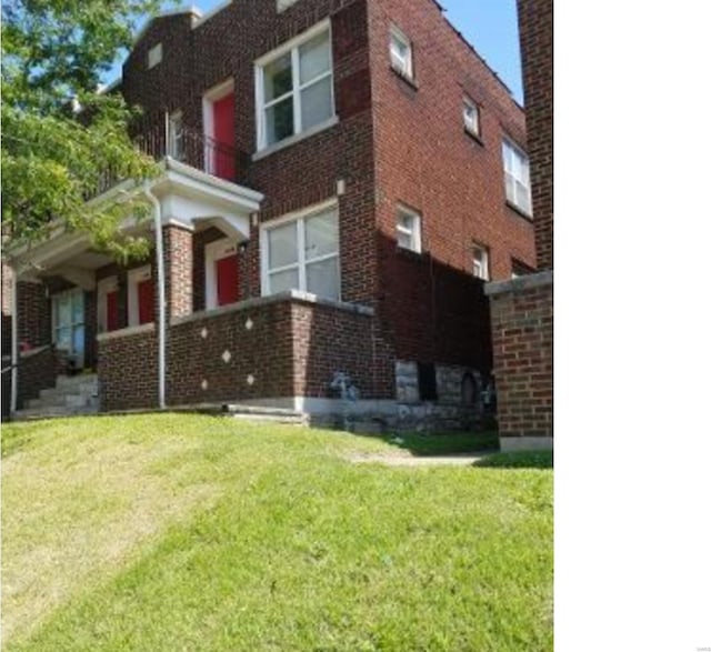 view of property exterior with a balcony and a lawn