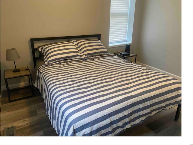 bedroom featuring dark hardwood / wood-style flooring