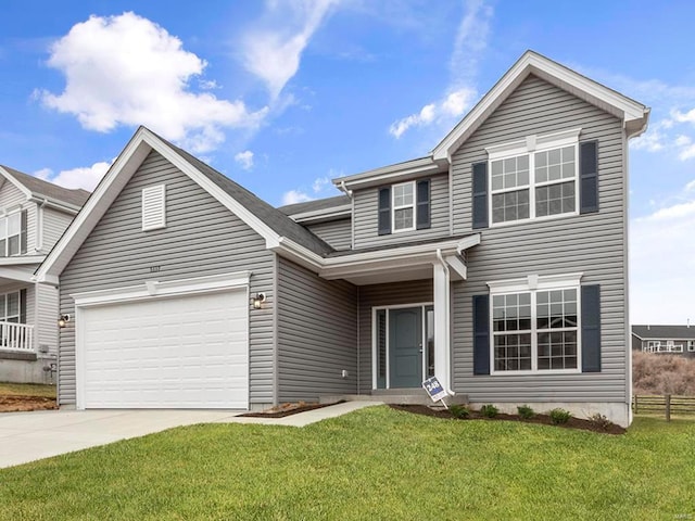 view of front of property featuring a garage and a front yard