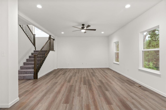 unfurnished living room with ceiling fan and light hardwood / wood-style floors