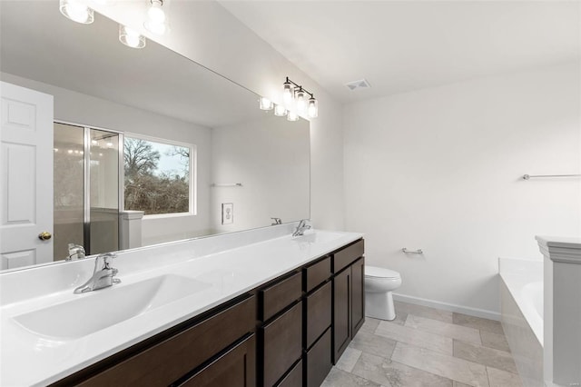 full bathroom featuring vanity, separate shower and tub, and toilet