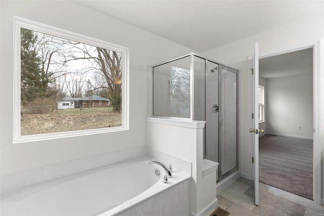 bathroom with tile patterned floors, plenty of natural light, and independent shower and bath