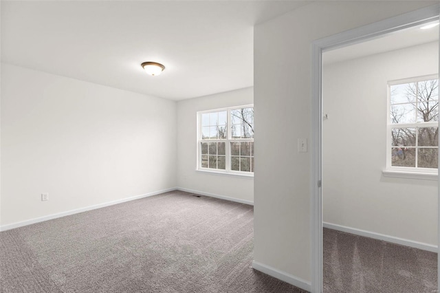 empty room with dark colored carpet