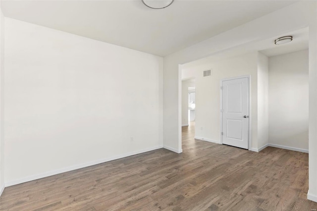 empty room with wood-type flooring