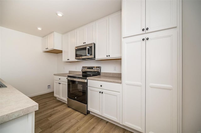 kitchen with stainless steel appliances and white cabinets