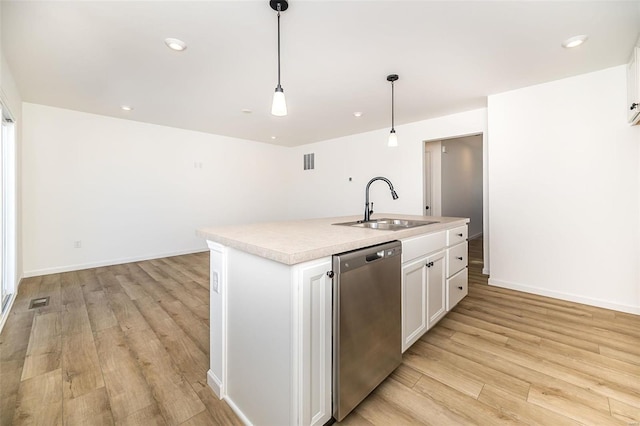 kitchen featuring pendant lighting, white cabinetry, sink, a kitchen island with sink, and stainless steel dishwasher