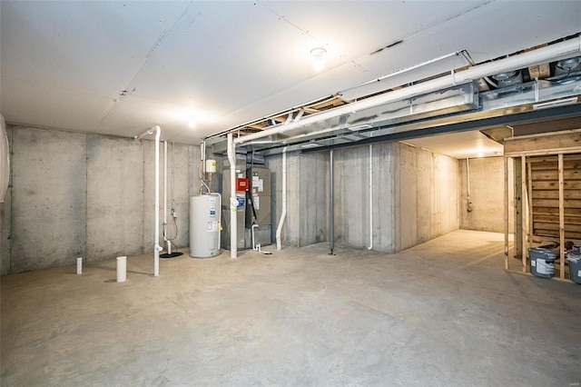 basement featuring electric water heater and heating unit