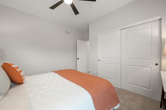 carpeted bedroom with a closet and ceiling fan