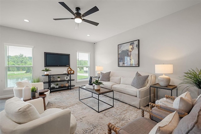 living room featuring wood-type flooring and ceiling fan