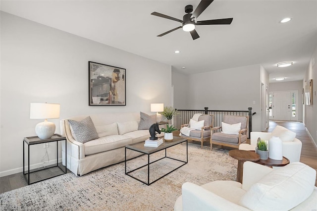 living room with ceiling fan and wood-type flooring