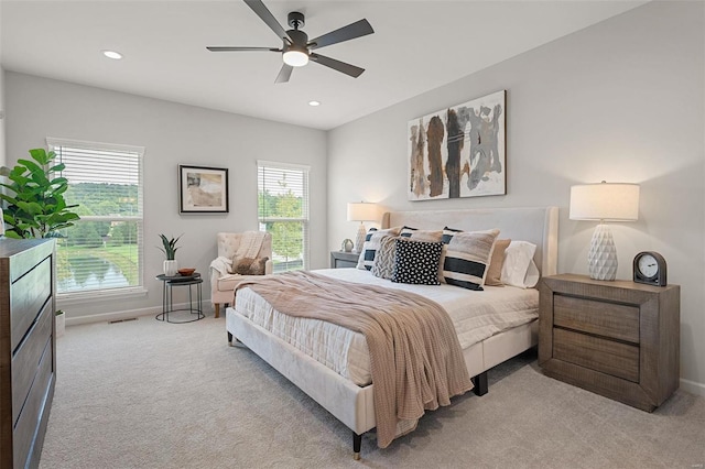 bedroom featuring ceiling fan and light colored carpet