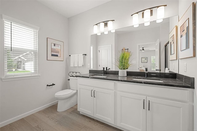 bathroom featuring ceiling fan, hardwood / wood-style floors, plenty of natural light, and toilet