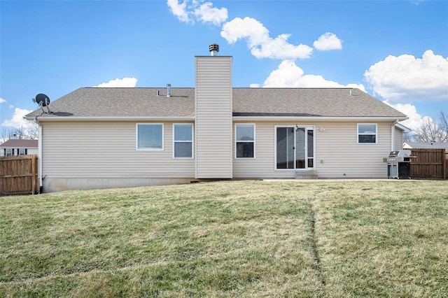 rear view of property featuring a lawn