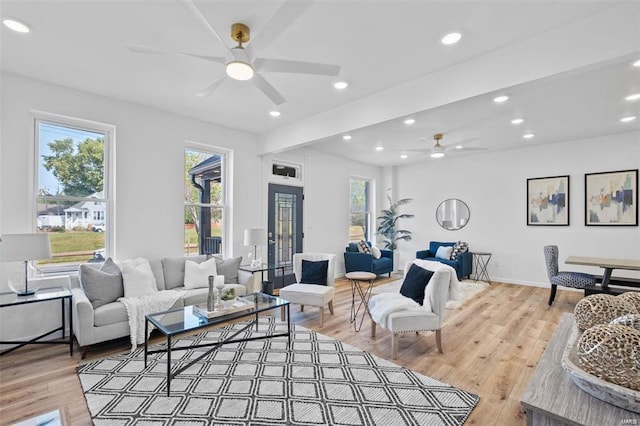 living room featuring ceiling fan and hardwood / wood-style flooring