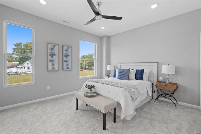 bedroom featuring light carpet, visible vents, and baseboards