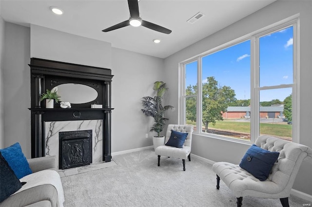 living area featuring visible vents, recessed lighting, carpet, a premium fireplace, and baseboards