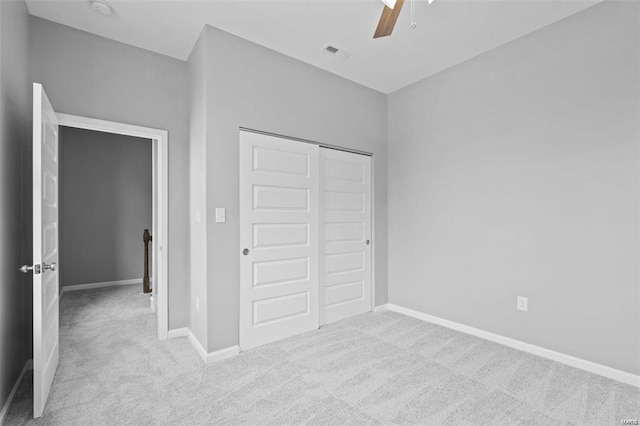 unfurnished bedroom featuring a closet, ceiling fan, baseboards, and carpet