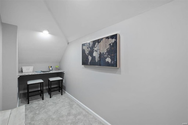 home office with baseboards, lofted ceiling, and carpet