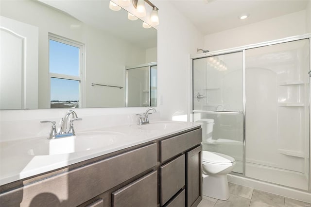 bathroom featuring toilet, vanity, an enclosed shower, and tile patterned flooring