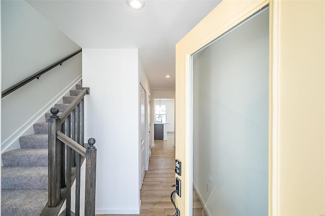 stairs with hardwood / wood-style floors