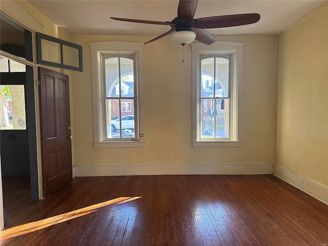 empty room with ceiling fan and dark hardwood / wood-style floors