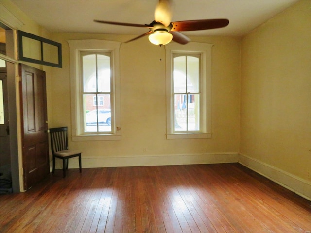 spare room with hardwood / wood-style flooring, a wealth of natural light, and ceiling fan