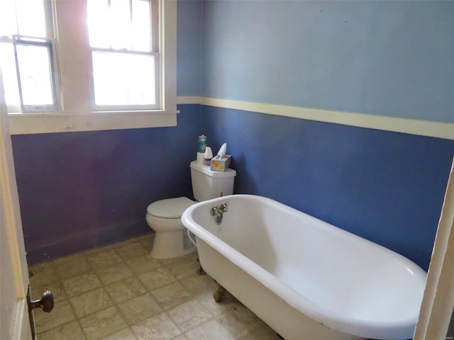 bathroom with toilet and a tub