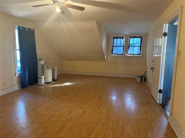 bonus room with ceiling fan, light hardwood / wood-style floors, and lofted ceiling