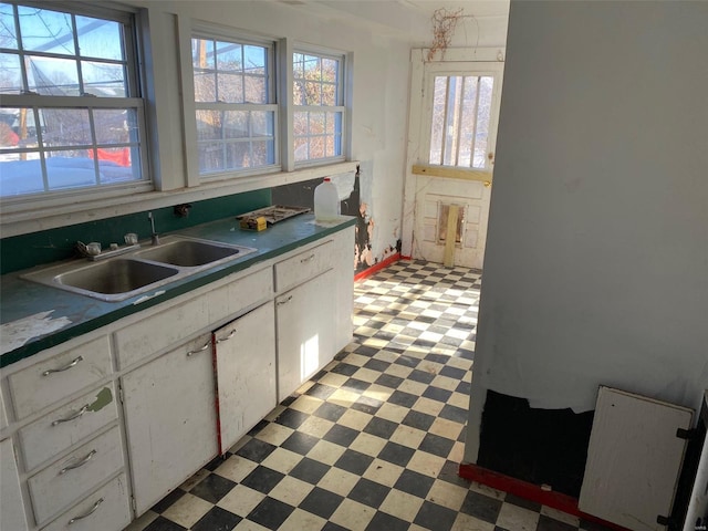 kitchen with white cabinetry and sink