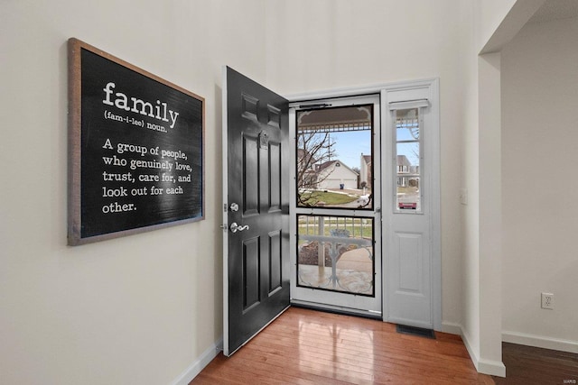 entryway with hardwood / wood-style flooring