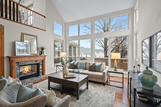 sunroom featuring a brick fireplace