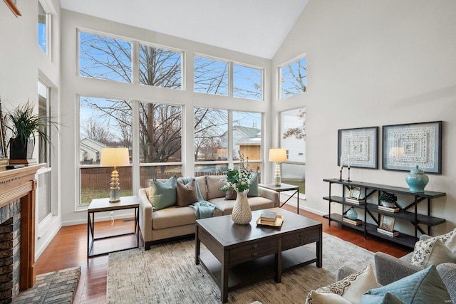 sunroom with lofted ceiling and a fireplace