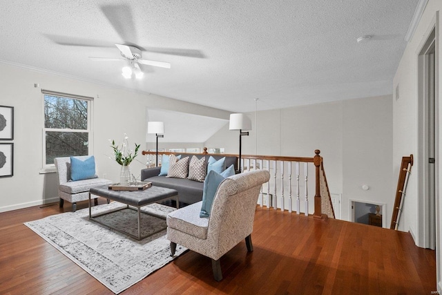 living room featuring ceiling fan, wood-type flooring, and a textured ceiling