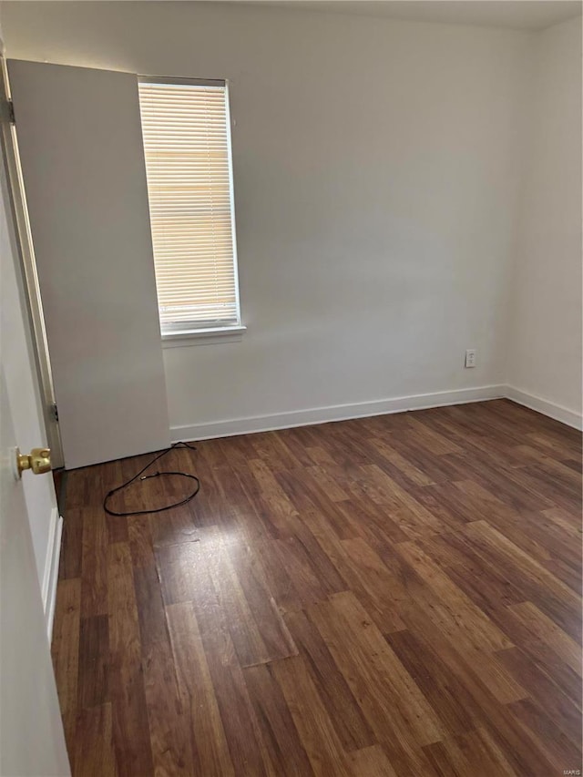 unfurnished room featuring dark wood-type flooring