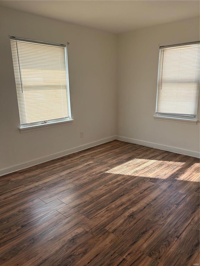 empty room featuring dark hardwood / wood-style flooring