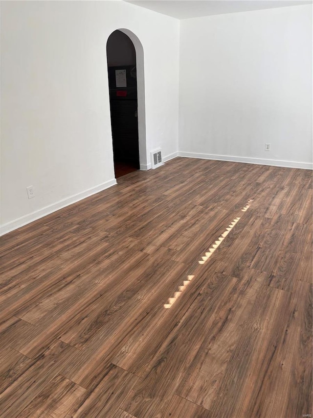 unfurnished room featuring dark wood-type flooring