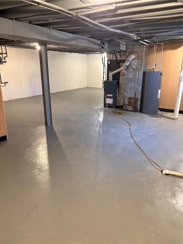 basement featuring heating unit and water heater