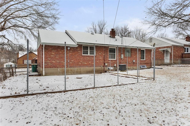 snow covered house with cooling unit