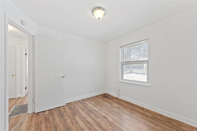 empty room with light hardwood / wood-style flooring