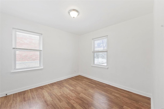 empty room with hardwood / wood-style flooring