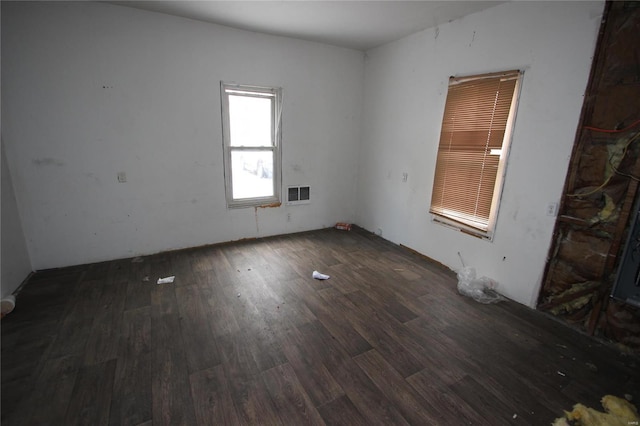 empty room with dark hardwood / wood-style flooring