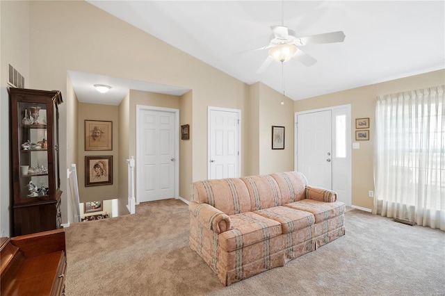 carpeted living room with vaulted ceiling, ceiling fan, and plenty of natural light