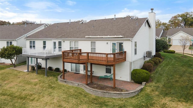 back of house featuring cooling unit, a patio area, a lawn, and a wooden deck