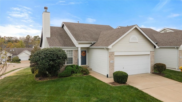 view of front of house featuring a garage and a front lawn