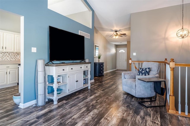 living room with dark hardwood / wood-style flooring, vaulted ceiling, and ceiling fan