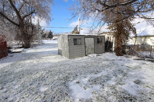 snow covered house with a storage unit