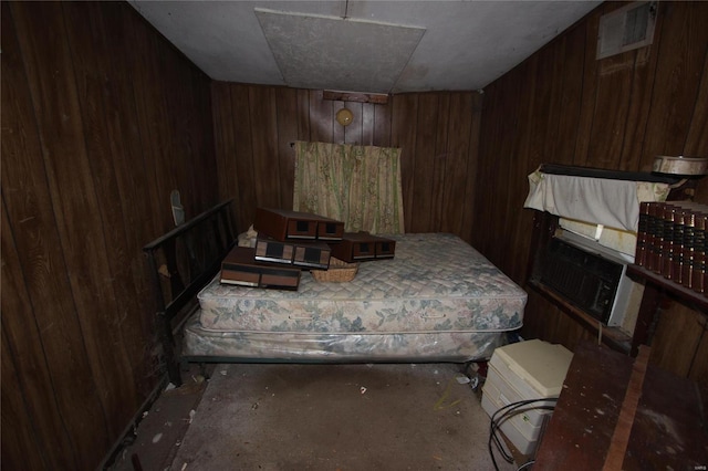 bedroom featuring wood walls