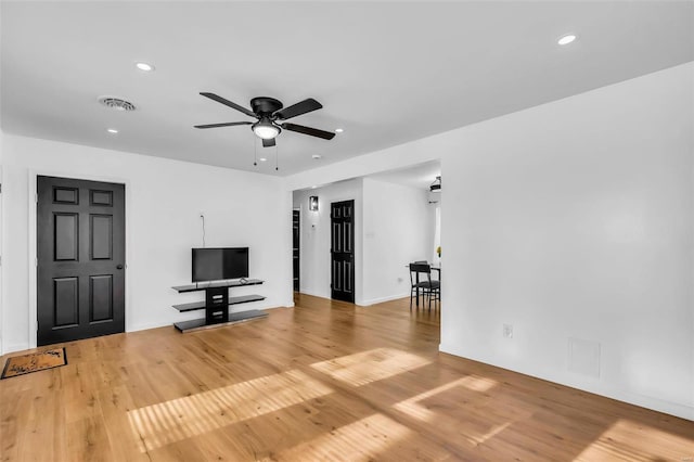 unfurnished living room with wood-type flooring and ceiling fan