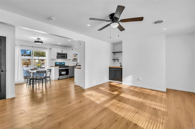 living room featuring ceiling fan and light wood-type flooring